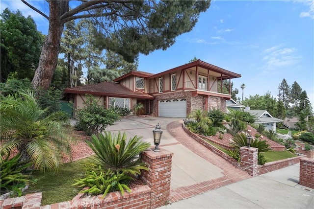11300 Dulcet Ave, Porter Ranch, CA 91326 - tudor house with concrete driveway, an attached garage, brick siding, and a balcony