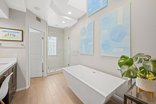 3358 Caminito Luna Nueva, Del Mar, CA 92014 - bathroom with vanity, a stall shower, a freestanding tub, wood finished floors, and recessed lighting