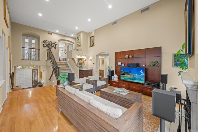 3358 Caminito Luna Nueva, Del Mar, CA 92014 - living room with arched walkways, stairway, recessed lighting, wood finished floors, and a high ceiling