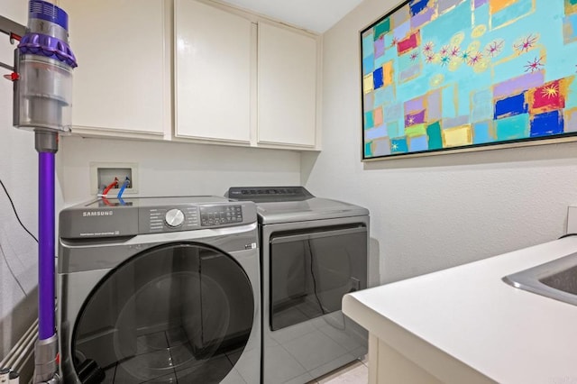 3358 Caminito Luna Nueva, Del Mar, CA 92014 - clothes washing area featuring cabinet space, washing machine and clothes dryer, and light tile patterned floors