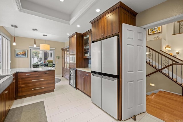 3358 Caminito Luna Nueva, Del Mar, CA 92014 - kitchen with freestanding refrigerator, light stone countertops, glass insert cabinets, recessed lighting, and decorative light fixtures