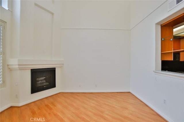 7100 La Tijera Blvd Unit B202, Los Angeles, CA 90045 - unfurnished living room featuring baseboards, a fireplace, visible vents, and wood finished floors