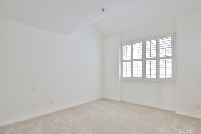 7100 La Tijera Blvd Unit B202, Los Angeles, CA 90045 - empty room with light colored carpet, baseboards, and lofted ceiling