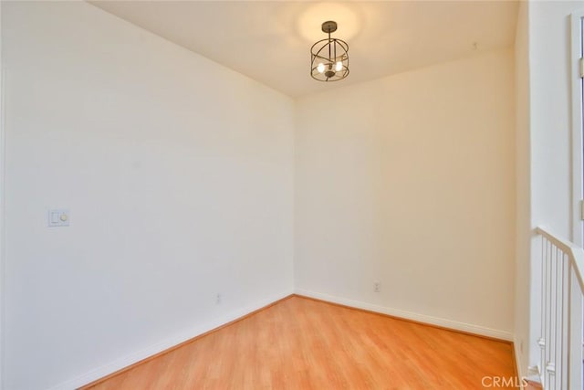 7100 La Tijera Blvd Unit B202, Los Angeles, CA 90045 - empty room featuring baseboards, a notable chandelier, and light wood-style floors