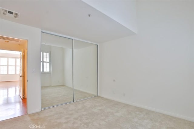 7100 La Tijera Blvd Unit B202, Los Angeles, CA 90045 - unfurnished bedroom featuring light carpet, a closet, and baseboards