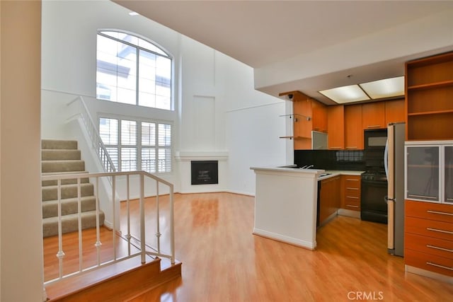 7100 La Tijera Blvd Unit B202, Los Angeles, CA 90045 - kitchen with black appliances, a healthy amount of sunlight, and light wood-style flooring