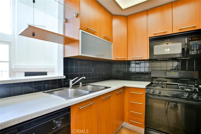 7100 La Tijera Blvd Unit B202, Los Angeles, CA 90045 - kitchen featuring light countertops, decorative backsplash, black appliances, and a sink