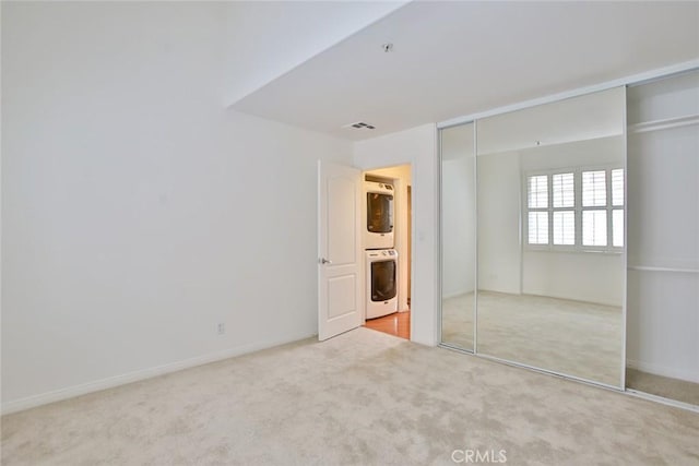 7100 La Tijera Blvd Unit B202, Los Angeles, CA 90045 - unfurnished bedroom with stacked washer / dryer, carpet floors, a closet, and baseboards