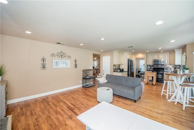 3251 Mountainside Dr, Corona, CA 92882 - living area featuring light wood-style floors, recessed lighting, and baseboards