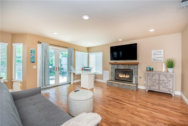 3251 Mountainside Dr, Corona, CA 92882 - living room featuring light wood-style flooring, a stone fireplace, french doors, baseboards, and recessed lighting
