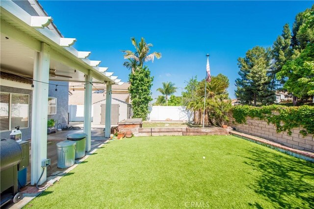 3251 Mountainside Dr, Corona, CA 92882 - view of yard featuring a ceiling fan, a storage unit, and an outdoor structure