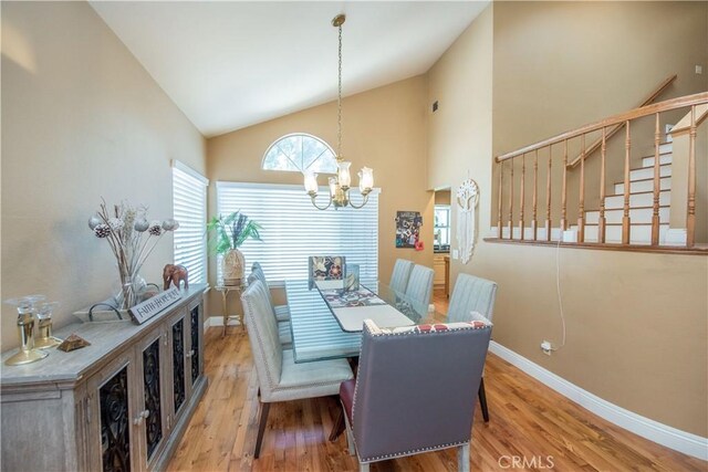 3251 Mountainside Dr, Corona, CA 92882 - dining room with a chandelier, wood finished floors, baseboards, high vaulted ceiling, and stairs
