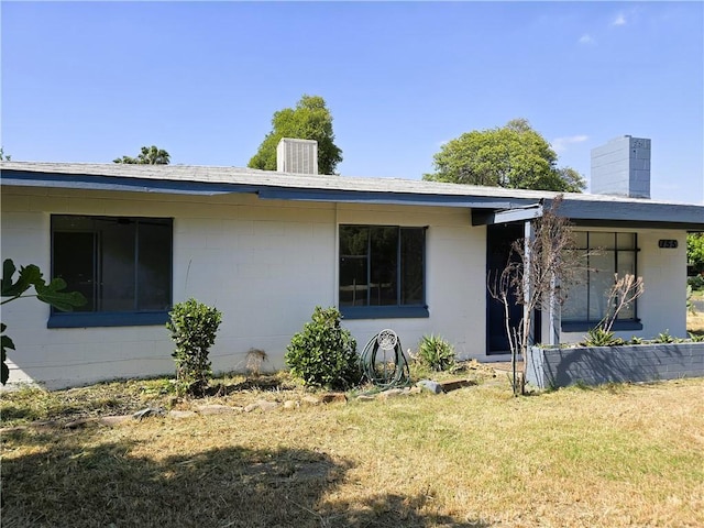 exterior space with a front lawn and a chimney