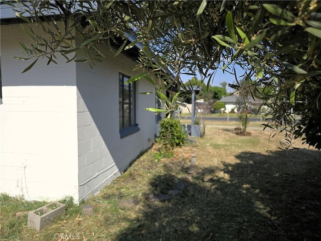 view of side of home featuring concrete block siding