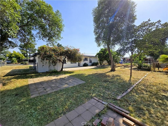 view of yard featuring a patio area and fence