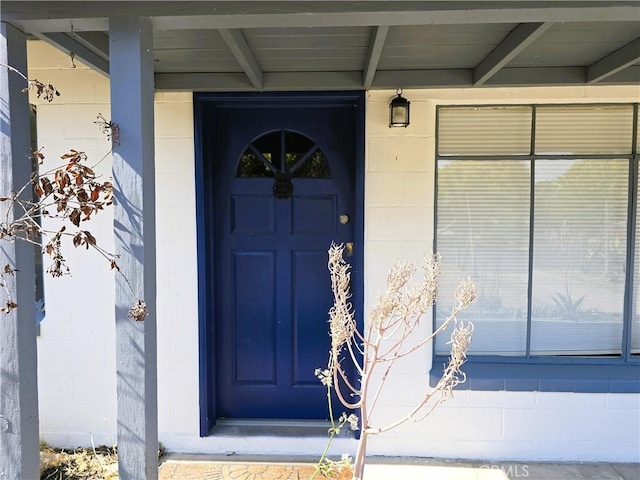 entrance to property with concrete block siding