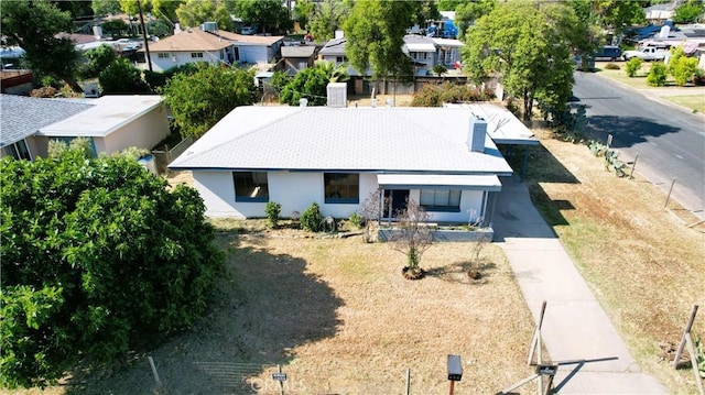 view of front of house with driveway, stucco siding, and a residential view