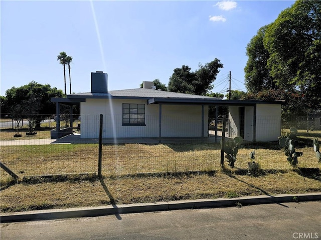 ranch-style house with a chimney and fence
