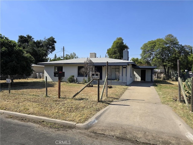 single story home with a chimney, fence, concrete driveway, a front lawn, and a carport