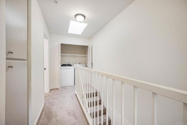 5704 Camino Del Cielo Unit 502, Bonsall, CA 92003 - hall with independent washer and dryer, baseboards, a skylight, an upstairs landing, and light colored carpet