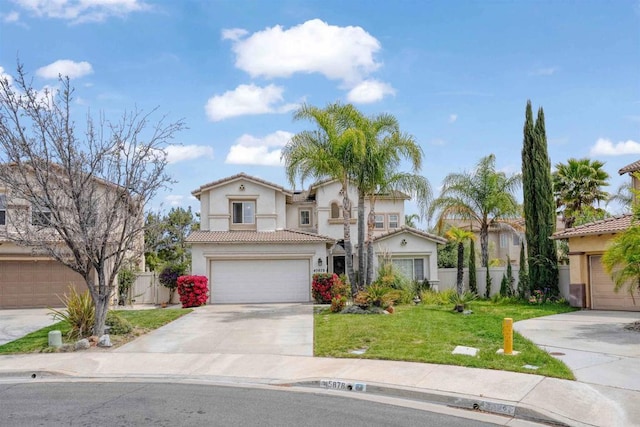 view of front of house featuring a tiled roof, fence, stucco siding, concrete driveway, and a front yard