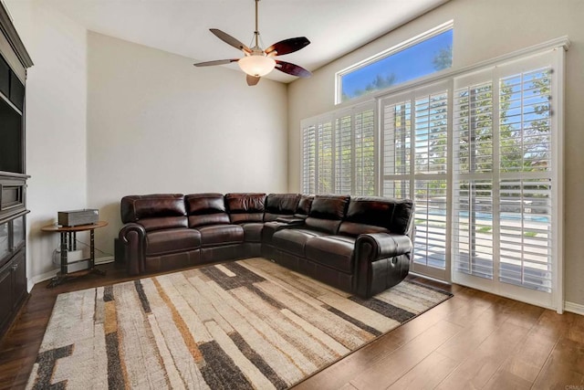 living room with ceiling fan and wood finished floors