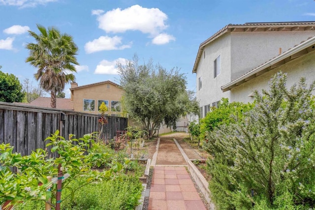 view of yard with a garden and a fenced backyard