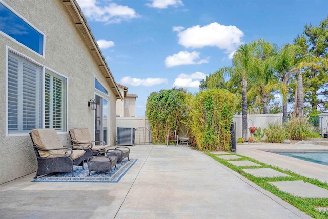 view of patio with cooling unit, an outdoor hangout area, a fenced in pool, and a fenced backyard