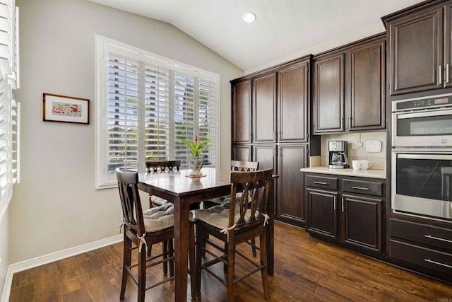 dining room featuring recessed lighting, vaulted ceiling, baseboards, and dark wood-style floors