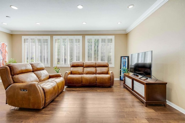 living area featuring wood-type flooring, baseboards, and ornamental molding