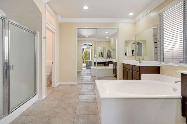 full bathroom with a stall shower, vanity, toilet, and a bath