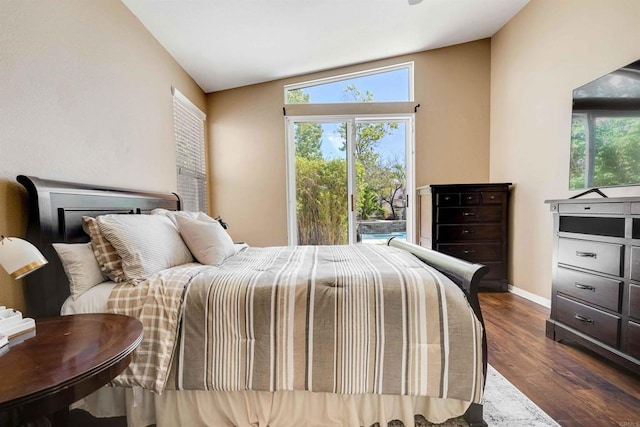 bedroom with vaulted ceiling, baseboards, dark wood-style floors, and multiple windows