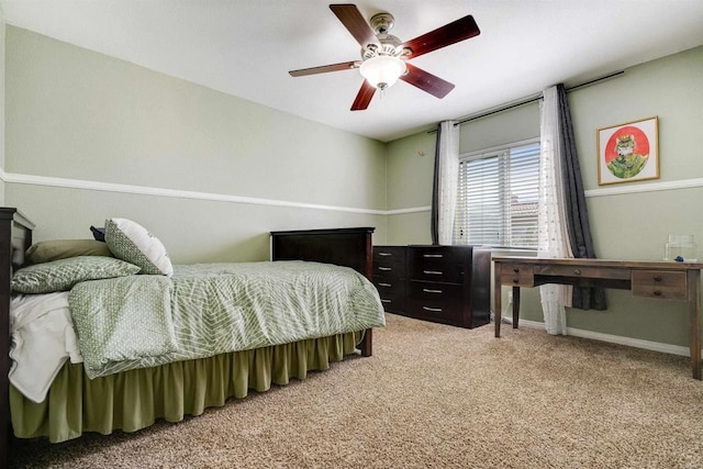 bedroom featuring light colored carpet, baseboards, and a ceiling fan