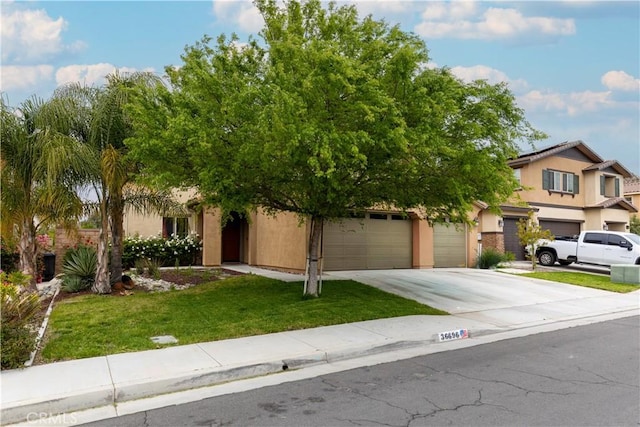 36696 Pavic Ct, Lake Elsinore, CA 92532 - obstructed view of property with concrete driveway, stucco siding, a front yard, and an attached garage
