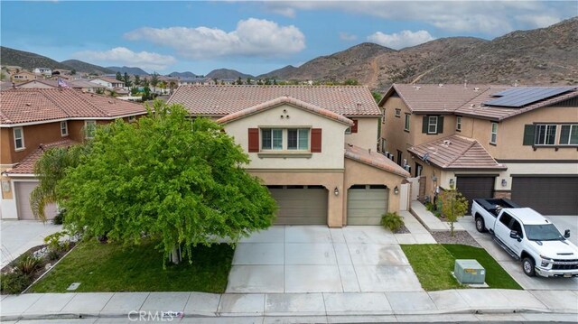 36696 Pavic Ct, Lake Elsinore, CA 92532 - mediterranean / spanish home featuring a residential view, an attached garage, driveway, a tile roof, and stucco siding