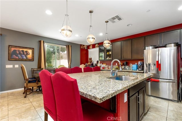 36696 Pavic Ct, Lake Elsinore, CA 92532 - kitchen featuring stainless steel refrigerator with ice dispenser, light tile patterned floors, recessed lighting, an island with sink, and decorative light fixtures