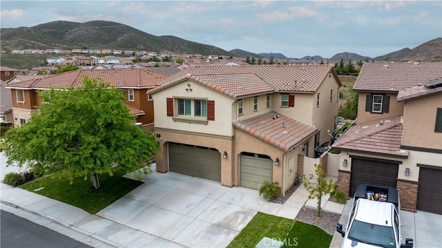 36696 Pavic Ct, Lake Elsinore, CA 92532 - mediterranean / spanish house featuring stucco siding, a residential view, a tile roof, and an attached garage