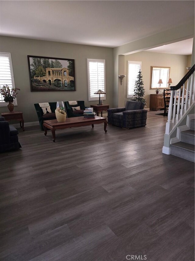 4990 Padre Ave, Rancho Cucamonga, CA 91739 - living room featuring baseboards, stairs, and dark wood-type flooring