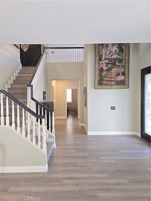 4990 Padre Ave, Rancho Cucamonga, CA 91739 - foyer featuring baseboards, a wealth of natural light, and wood finished floors