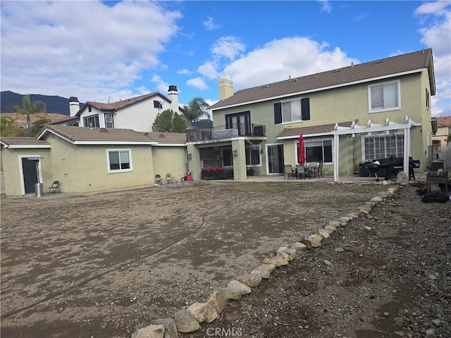 4990 Padre Ave, Rancho Cucamonga, CA 91739 - rear view of house with a balcony, a patio, a pergola, and stucco siding