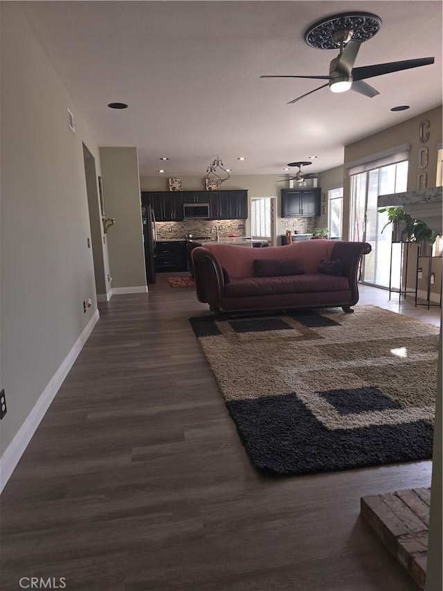 4990 Padre Ave, Rancho Cucamonga, CA 91739 - living area with dark wood-style flooring, baseboards, a ceiling fan, and visible vents