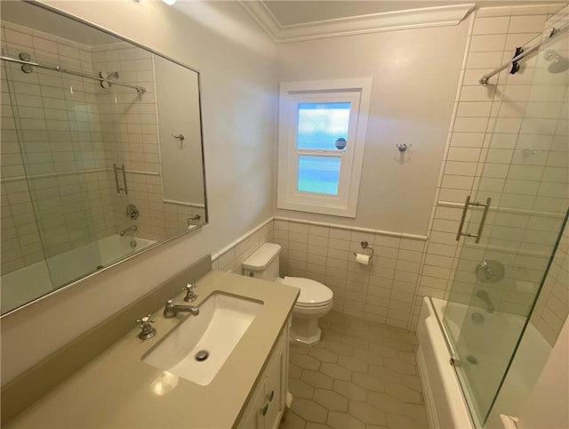 bathroom featuring tile walls, enclosed tub / shower combo, toilet, tile patterned flooring, and crown molding