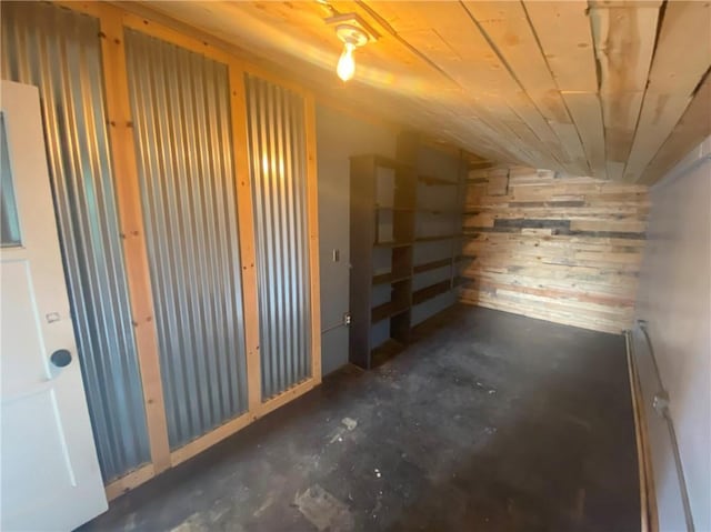 basement featuring wood walls
