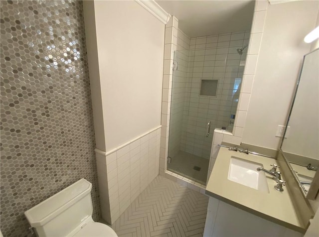 full bathroom with vanity, toilet, tile walls, and a shower stall