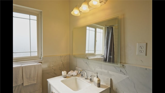 3206 Candlewood Dr, Bakersfield, CA 93306 - full bathroom featuring wainscoting, vanity, tile walls, and a wealth of natural light