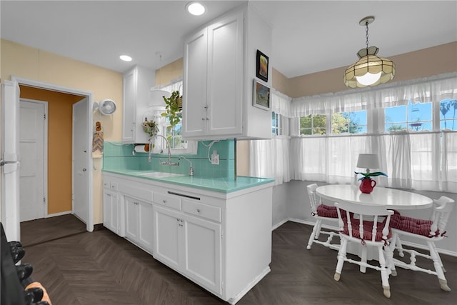 7111 Texhoma Ave, Van Nuys, CA 91406 - kitchen featuring a sink, light countertops, white cabinetry, decorative backsplash, and recessed lighting