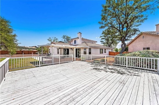 wooden terrace with fence and a lawn