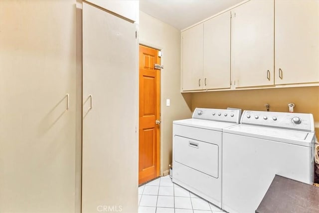 17861 Cathedral Pl, Encino, CA 91316 - washroom with cabinet space, washing machine and clothes dryer, and light tile patterned flooring