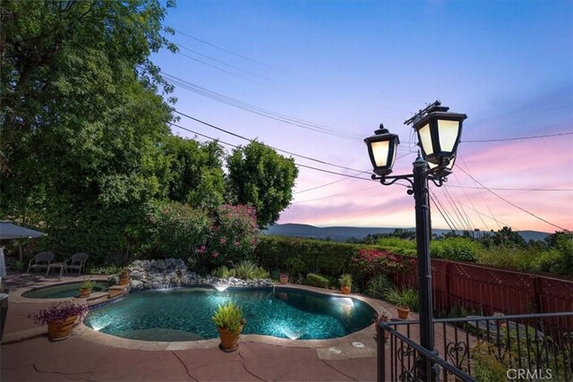 17861 Cathedral Pl, Encino, CA 91316 - pool at dusk with a patio area and a pool with connected hot tub