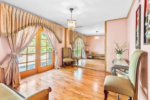 17861 Cathedral Pl, Encino, CA 91316 - sitting room featuring a chandelier, healthy amount of natural light, wood finished floors, and ornamental molding